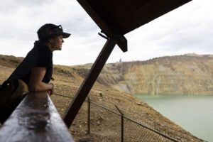 Josie Grigsby looks out at the Berkeley Pit during a presentation on the migratory waterfowl protection program at the pit's viewing stand in Butte on July 16. Photo Credit: Megan Nielsen, Montana Standard