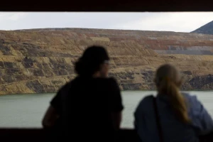 From left, Brett Oliver and Katie Pellicore look out at the Berkeley Pit during a presentation on the migratory waterfowl protection program at the viewing stand in Butte on July 16. Photo Credit: Megan Nielsen, Montana Standard