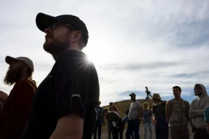 Attendees listen during a tour led by CTEC to the historic Pilot Butte Mine in Butte on Thursday. The Diamond headframe is seen in the background. MEGAN NIELSEN, Montana Standard