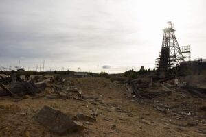 Debris is strewn across the wasteland of Berkeley Pit overburden under the Badger State Mine headframe during a tour led by CTEC to the historic Pilot Butte Mine in Butte on Thursday. MEGAN NIELSEN, Montana Standard