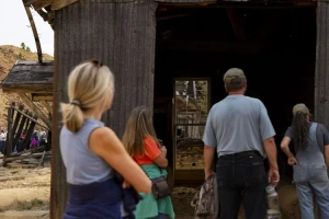 Attendees look into one of the structures at the historic Pilot Butte Mine mineyard during a tour led by CTEC to the Pilot Butte Mine in Butte on Thursday. MEGAN NIELSEN, Montana Standard